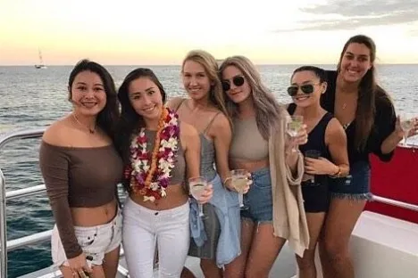 a couple of people that are standing in front of a body of water