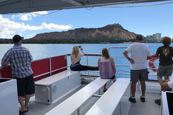 a group of people standing next to a body of water