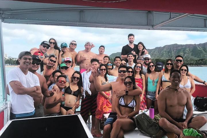 a group of people standing in front of a crowd posing for the camera