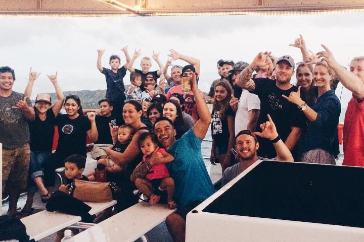 a group of people standing in front of a crowd posing for the camera