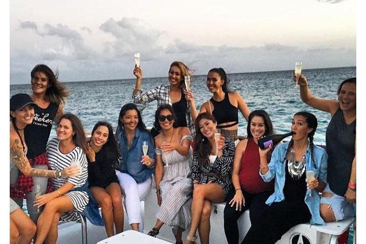 a group of people on a boat posing for the camera