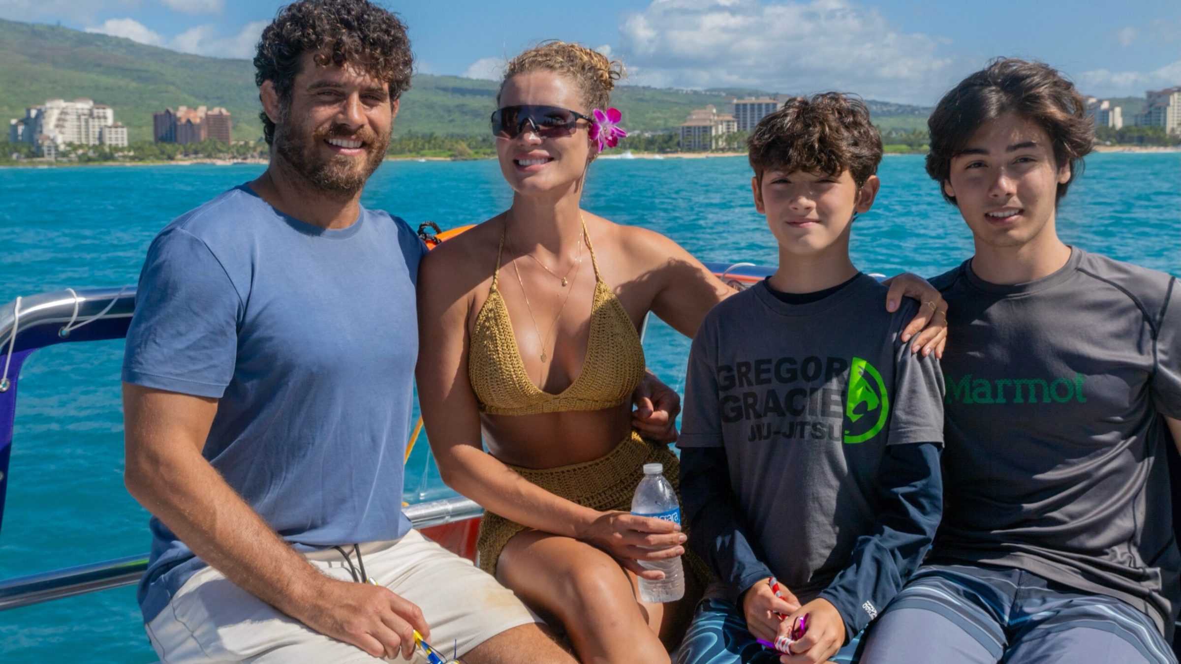 a group of people standing next to a body of water