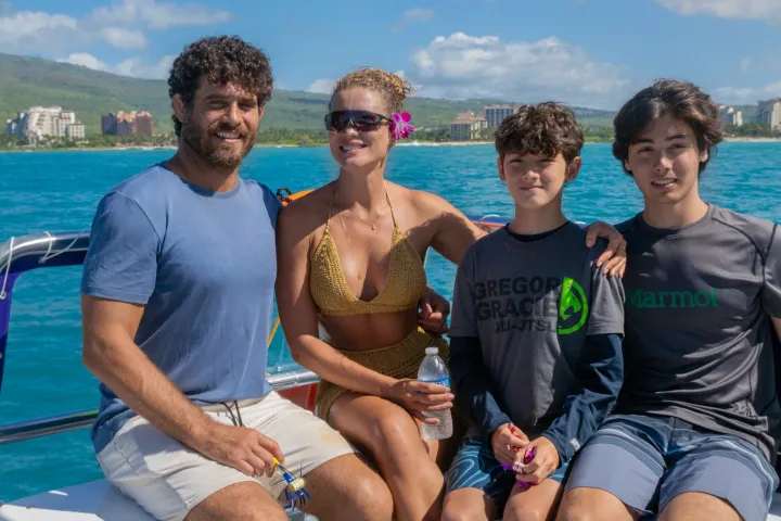 a group of people standing next to a body of water