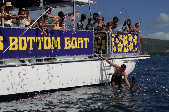 a group of people riding on the back of a boat