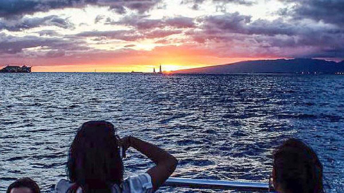 a person sitting in front of a body of water