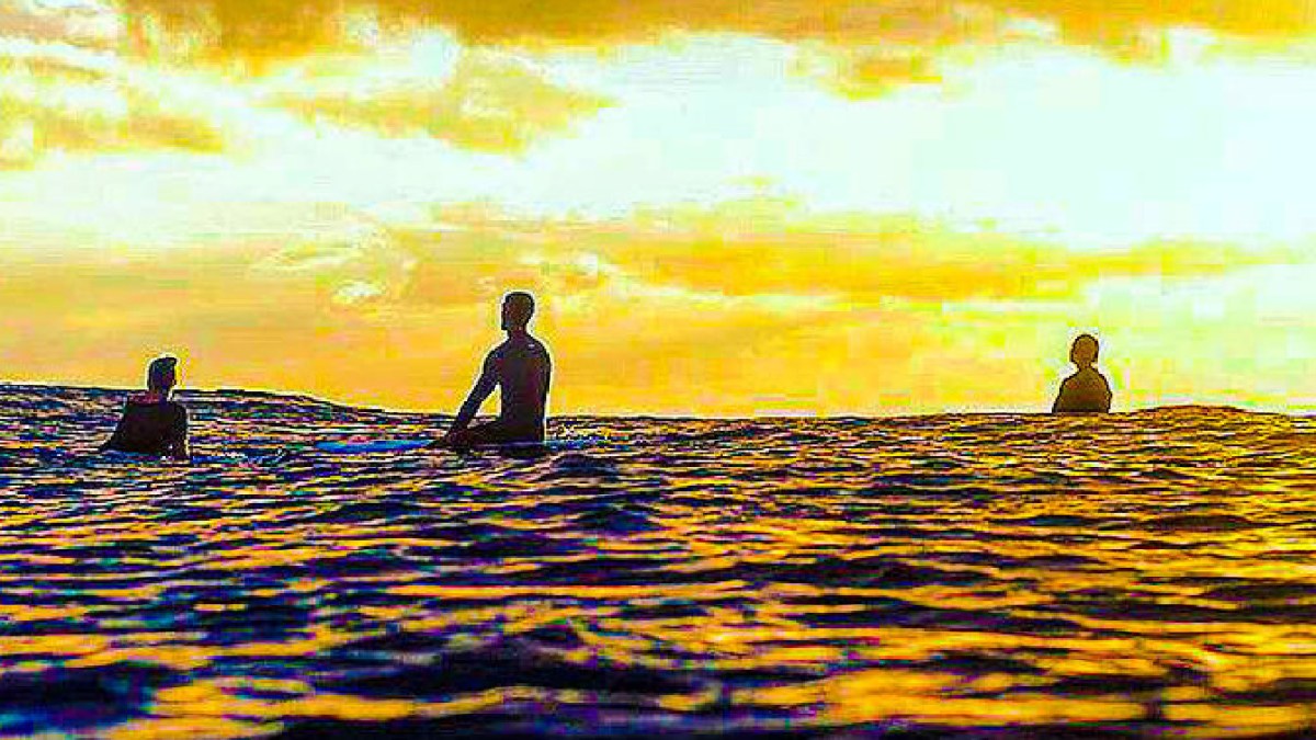 a group of people standing next to a body of water