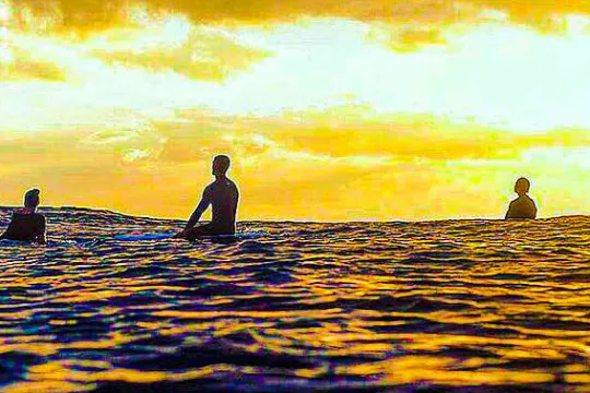 a group of people standing next to a body of water