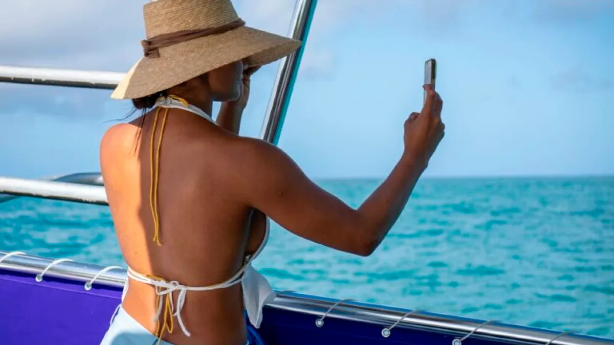 a woman standing on a boat in the water