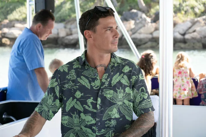 a man and a woman standing in front of a window