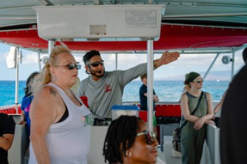 a group of people standing on a boat